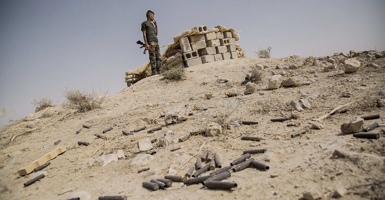 A Peshmerga soldier watches ISIS lines in the distance at a military outpost located at the entrance of Gwer, Iraq. (Photo: Vianney Le Caer/Newscom)